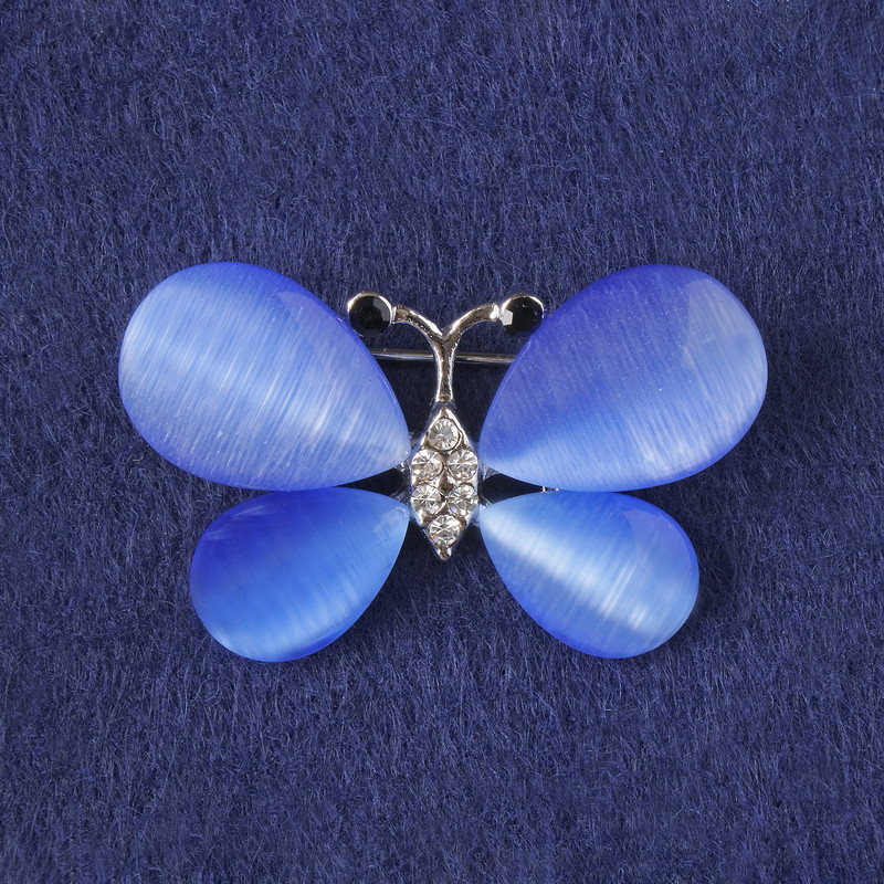 Broșă fluture cu ochi de pisică albastru, cristale albe, metal argintiu 25x38 mm+