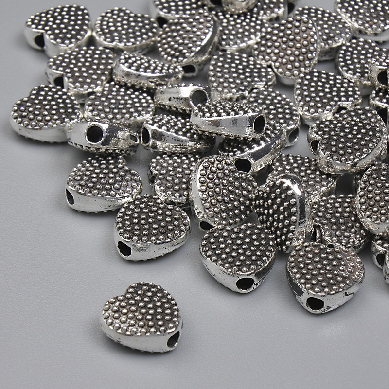 Furnitură mărgea-inserție inimă, culoare metal argintiu, diametru 7 mm ± gaură, diametru 1,3 mm ± ambalare 20 g (~40 buc.)