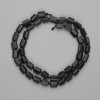 Mărgele din șungit, tăiate cu fațete 7–8×5–6 mm, lungime aproximativă 40 cm, pe șnur