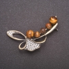 Broșă cu piatră naturală – ochiul de tigru, în formă de crenguță, culoare bronz, 58×36 mm