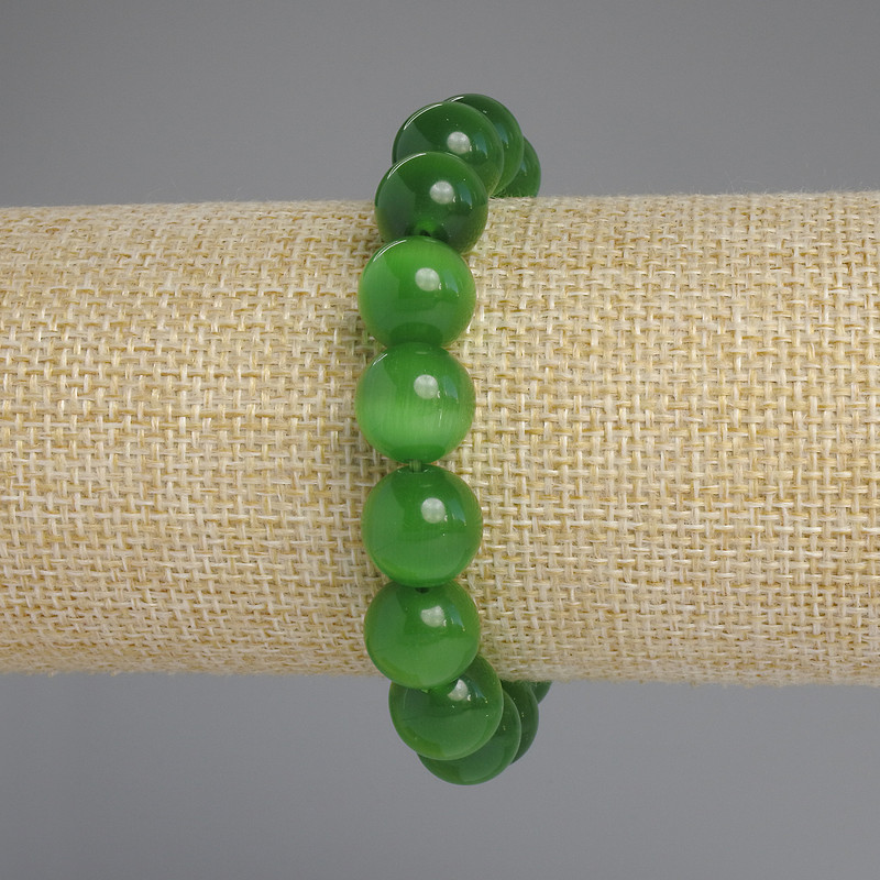 Brățară cu piatra ochiului pisicii, bile lucioase, diametrul aproximativ de 9,5 mm, lungime 18 cm, pe elastic