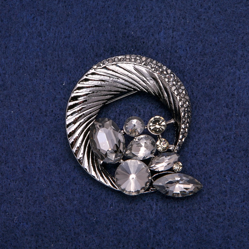 Broșă rotundă cu strasuri, împletită într-o compoziție frumoasă, metal închis 45×50 mm